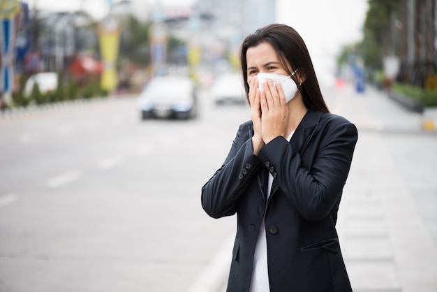 Woman in a suit wearing Protective face mask