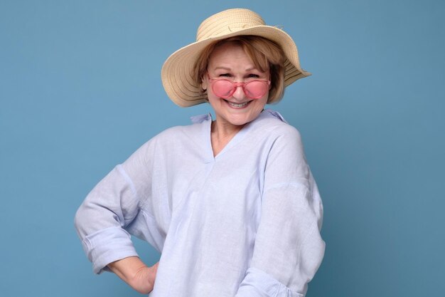 Woman in summer hat holding smiling posing to the camera ready for vacation