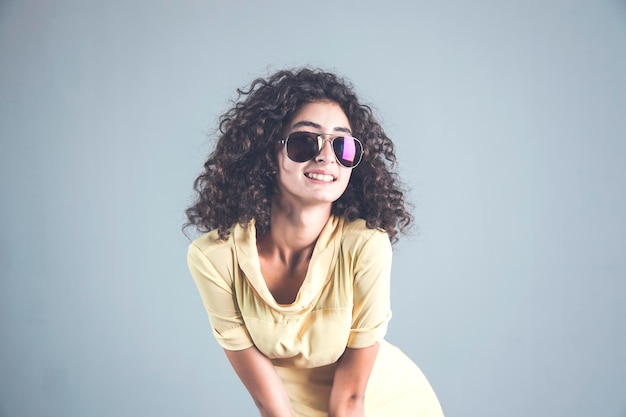 Woman in sunglasses in studio