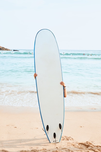 Woman Surfer Hide Behind White Surf Board on Beach