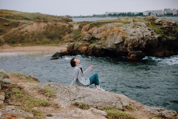 Woman sweaters cloudy sea admiring nature Lifestyle