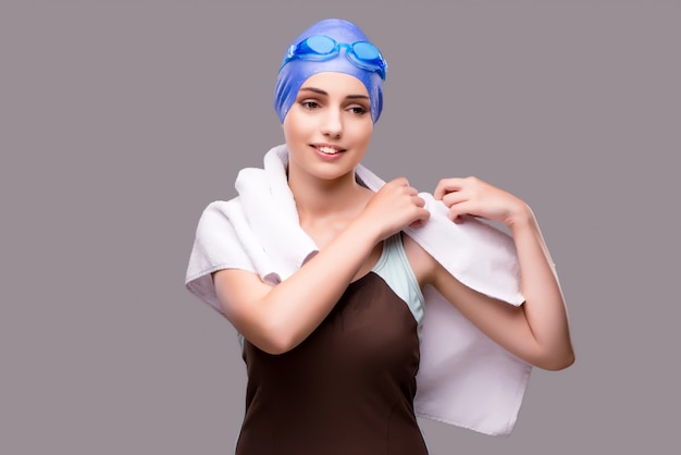 Woman swimmer against grey background