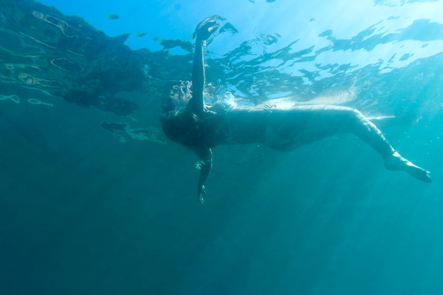 Woman swimming under the ocean