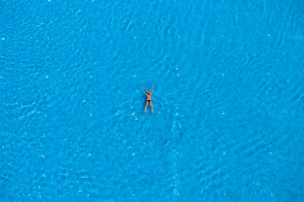 Woman swimming in a pool top view Summer travel and vacation concept