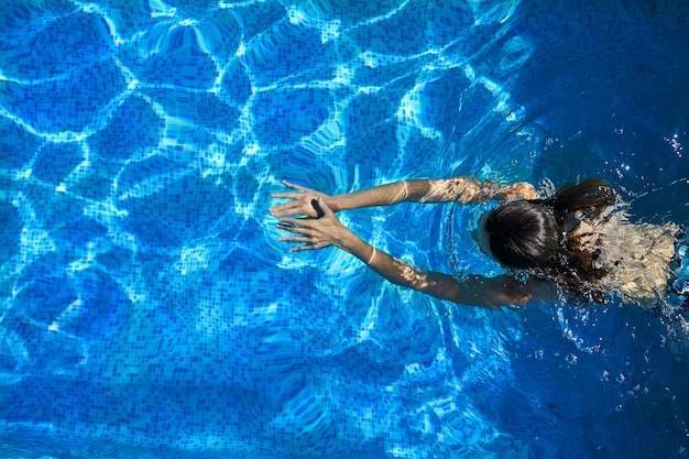 Woman swimming in the pool