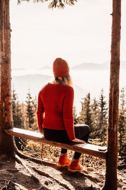 Woman swinging on swing in sunny winter dayin the ferest Wooden swing with swinging free happy woman outdoors Healthy lifestyle vacation Zazriva slovakia