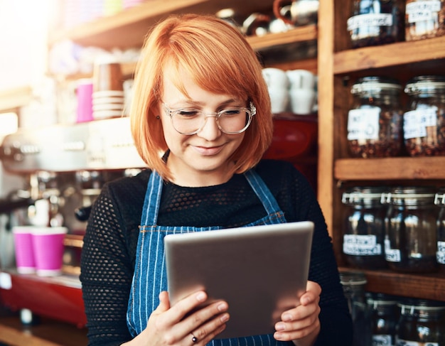 Woman tablet and cafe as waitress in small business with happiness in restaurant or coffee shop Female person cafeteria and bistro for food service as entrepreneur in startup in New York City