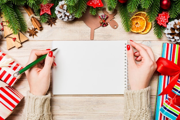 Woman taking notes on Christmas table