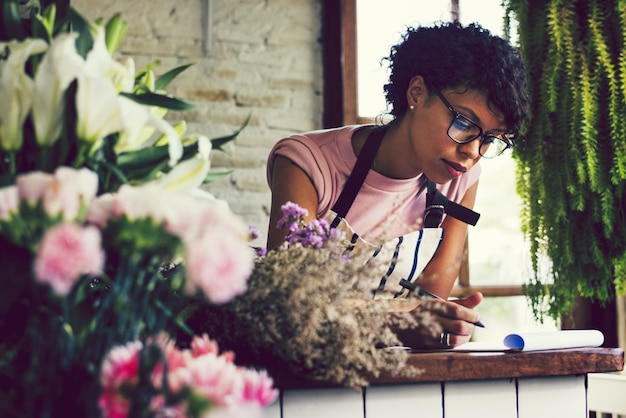 Woman taking notes in a flower shop