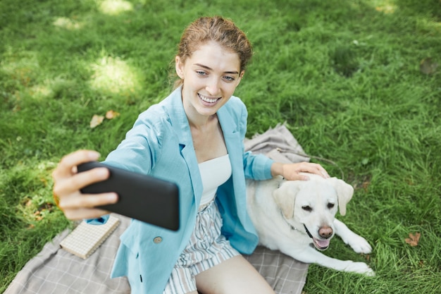 Woman Taking Photo with Dog