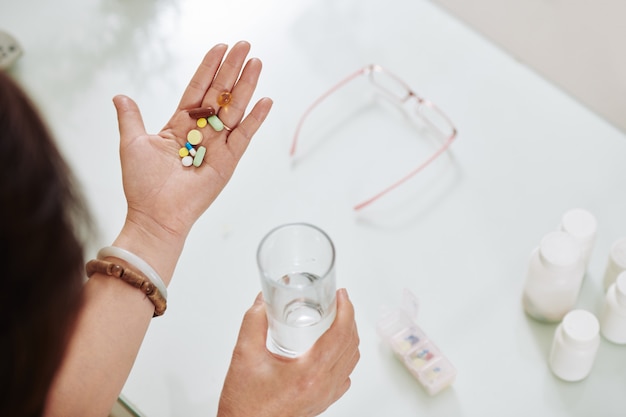 Woman taking pills and supplements