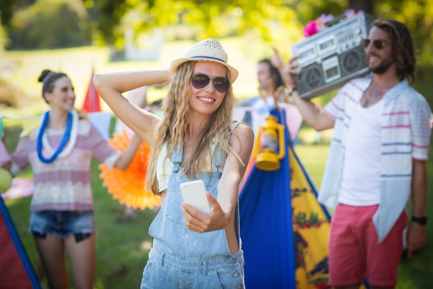 Woman taking selfie at campsite