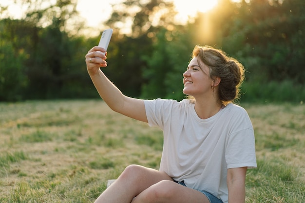 Woman taking selfie on mobile phone lifestyle mobility concept and modern wireless communication tec...