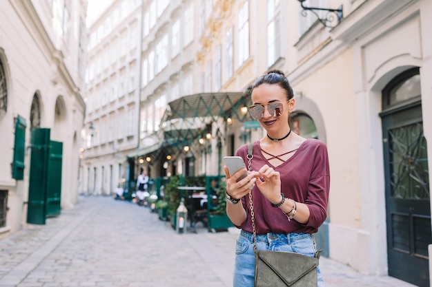 Woman talk by her smartphone in city young attractive tourist outdoors in italian city