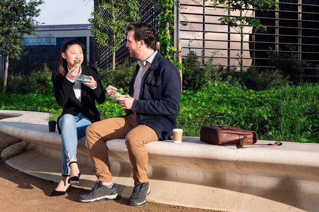 Woman talking and eating a salad with her partner