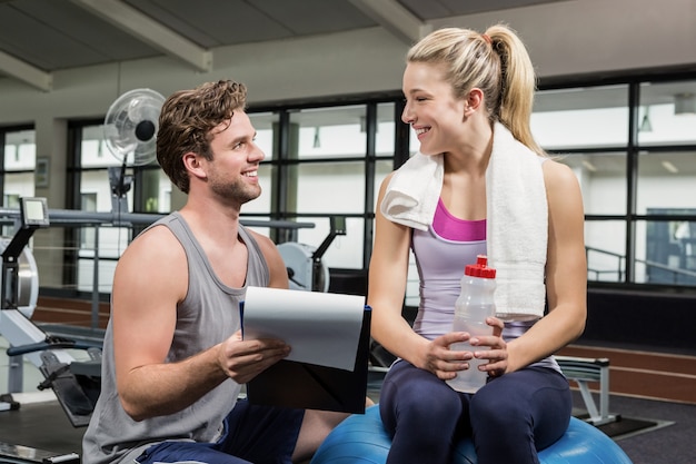 Woman talking to her trainer after a workout