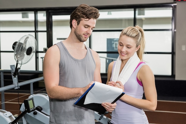 Woman talking to her trainer after a workout