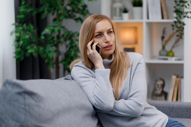 Woman talking on mobile on couch