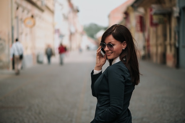 Woman talking on the mobile while exploring the city