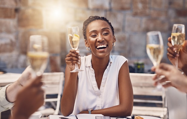 Woman talking for toast with celebration champagne at party with friends wine for success at restaurant and drinks at social event Happy black woman with smile and glass at birthday dinner at pub