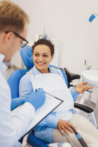 Woman talking with dentist in medical room