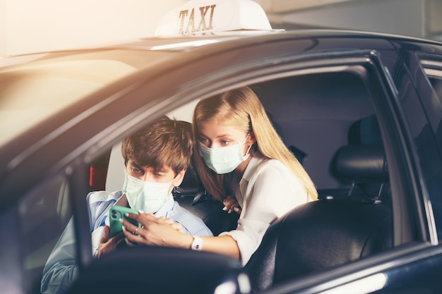 woman in a taxi showing address on phone