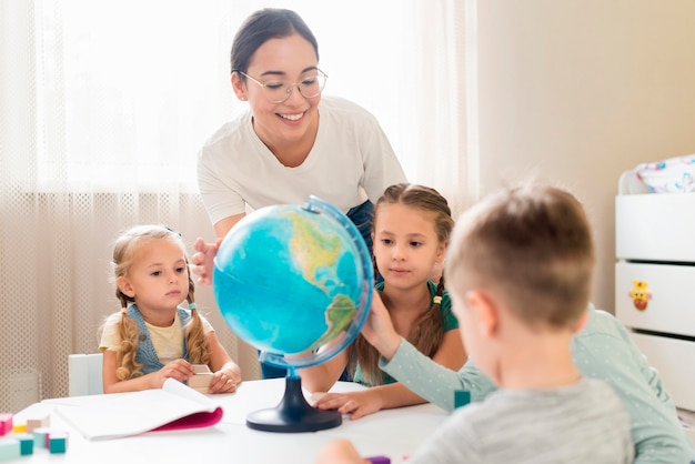 Woman teaching geography to kids