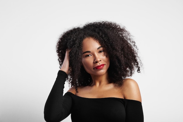 Woman touches her curly afro hair