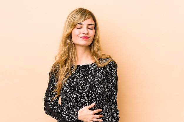 Woman touches tummy in studio