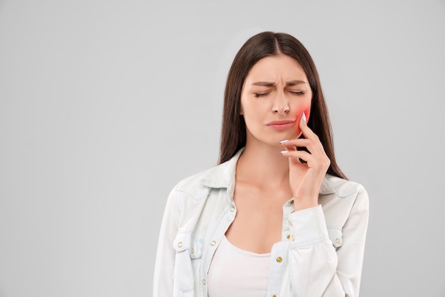 Woman touching mouth because of toothache