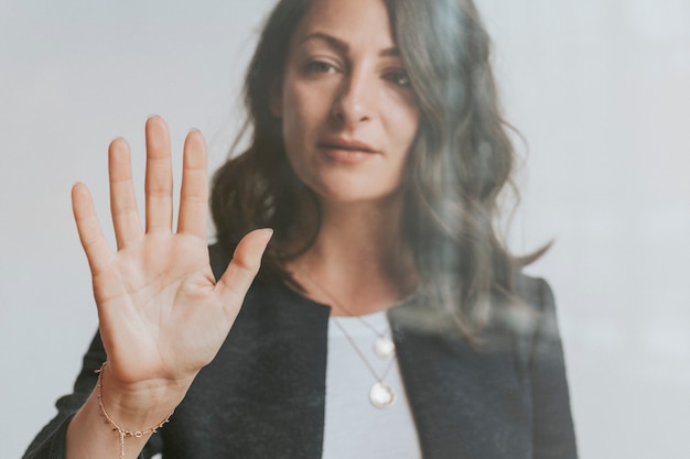 Woman touching a screen with her palm