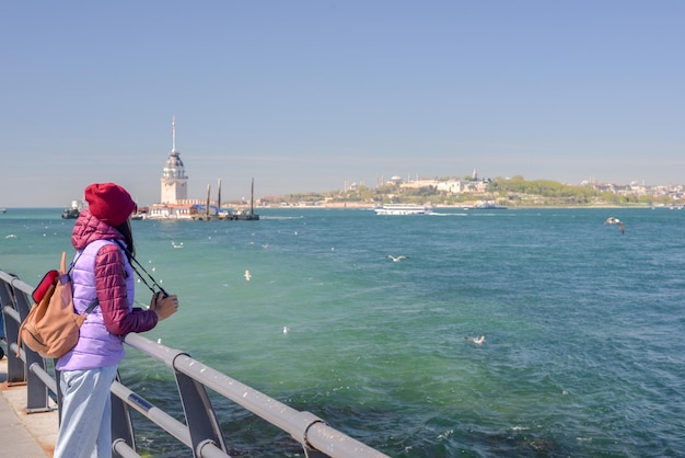 A woman tourist enjoys a view of the Maiden's Tower The Maiden's Tower also known as