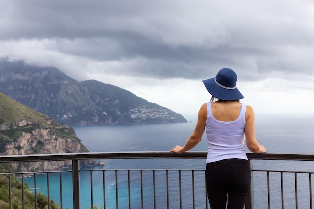 Woman tourist looking at Mountain Landscape by the Tyrrhenian Sea Amalfi Coast Italy