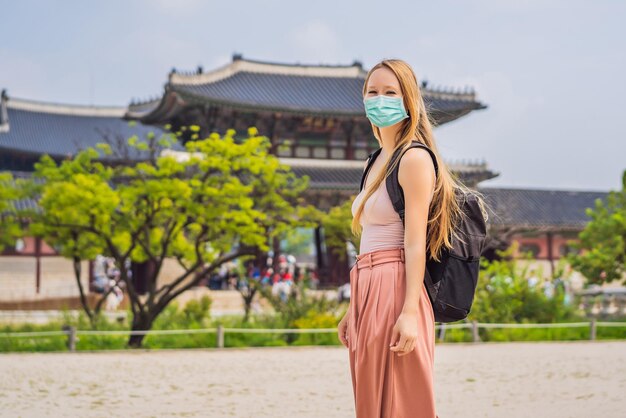 Woman tourist in medical mask in seoul south korea travel to korea concept tourists fear the ncov