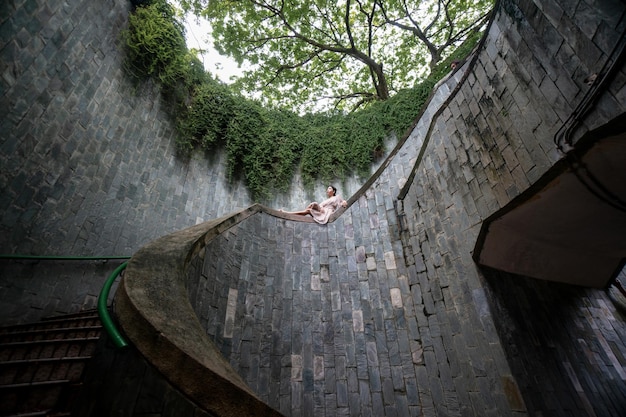 Woman tourist sitting at the staircase at Fort Canning Park popular landmark destination in Singapore