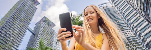 Woman tourist using navigation app on the mobile phone navigation map on a smartphone in a big city