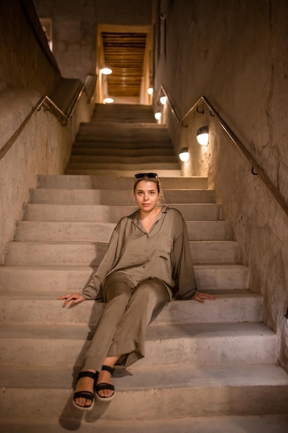 Woman tourist walking in Al Seef Meraas Dubai old historical district with traditional Arabic architecture