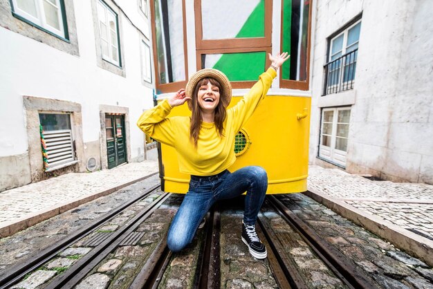 Woman tourist with famous yellow funicular tram of Lisbon Portugal