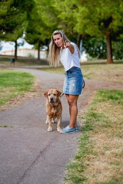 Woman training dog at the park.