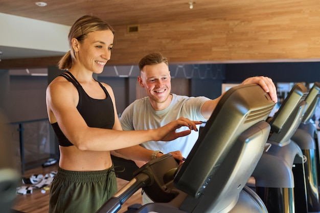 Woman training with instructor in gym