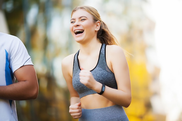 Woman training with personal trainer at park