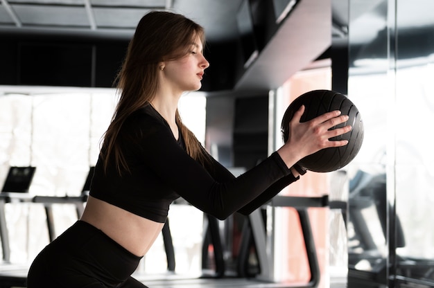 Woman training with weight lifting