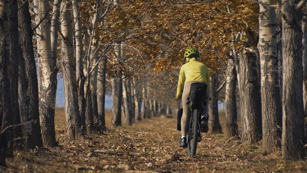 The woman travel on mixed terrain cycle touring with bikepacking. The traveler journey with bicycle bags. Sport tourism bikepacking.