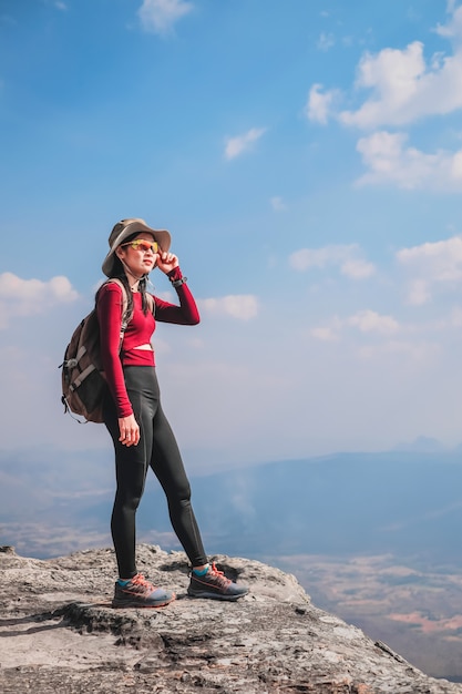 woman traveler are on top of the mountain and looking for view of nature on holiday.