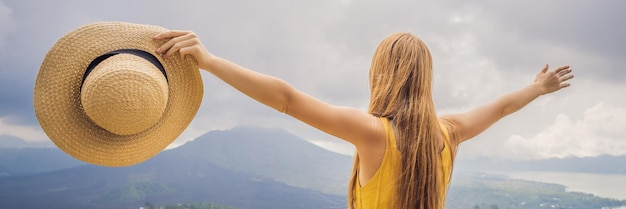 Woman traveler looking at batur volcano indonesia banner long format