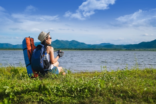 woman traveler sitting near the lake  in the mountain 