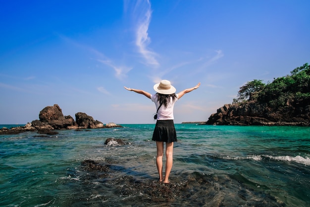 woman traveler standing and happy on the beach. 