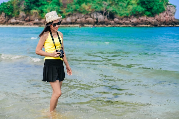 Woman traveler standing and happy on the beach. 