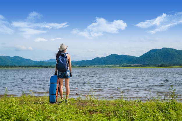 woman traveler standing near the lake  in the mountain