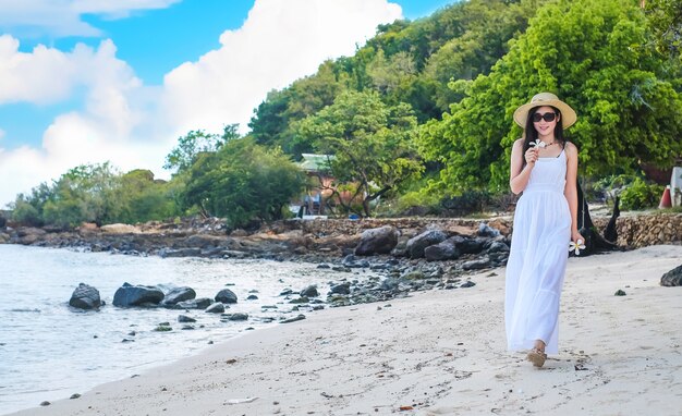 woman traveler walking on the beach and enjoying on holiday.